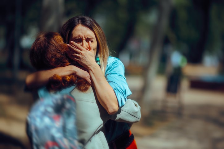 Depressed girl finding emotional support with her sister